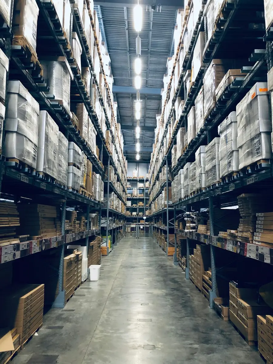 Warehouse aisle with palletized inventory on tall racks